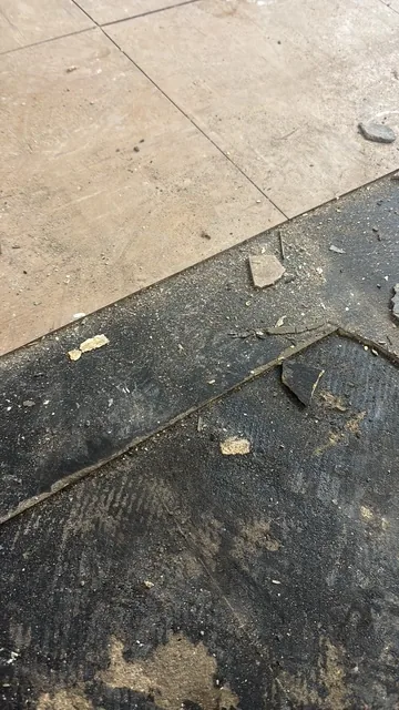 Black bitumen mastic floor removal in a SW15 flat